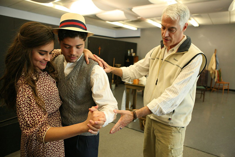 Students rehearsing a period dance with Knowles for an Academy graduation Play